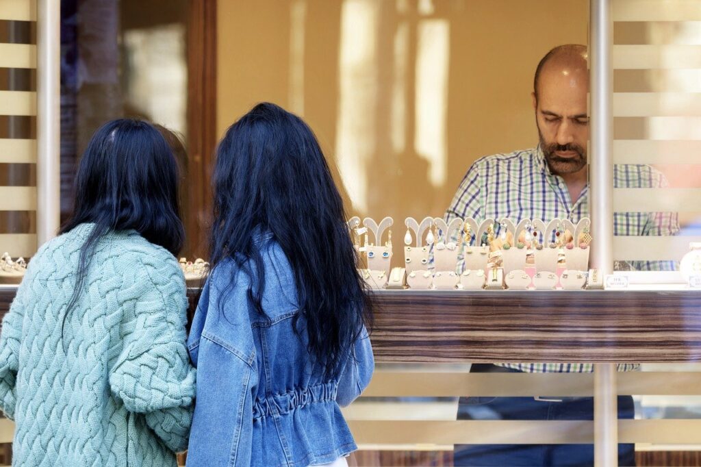 Jewellery Business, Customers admire sparkling diamond jewelry in a Sandton City store window.